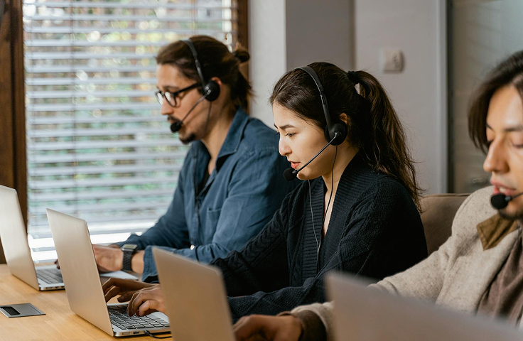 Customer service representatives providing support in a professional office setting